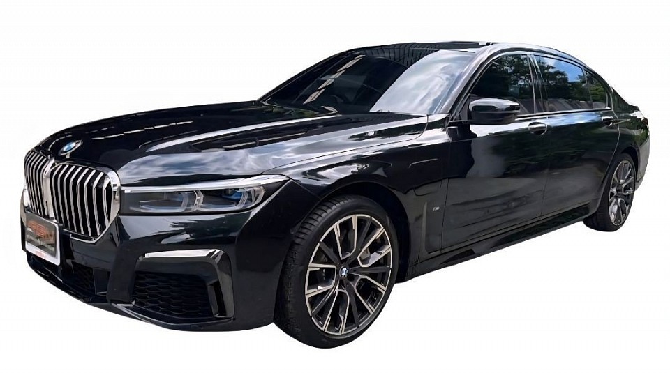 BMW luxury car 2 people, 2 suitcases,